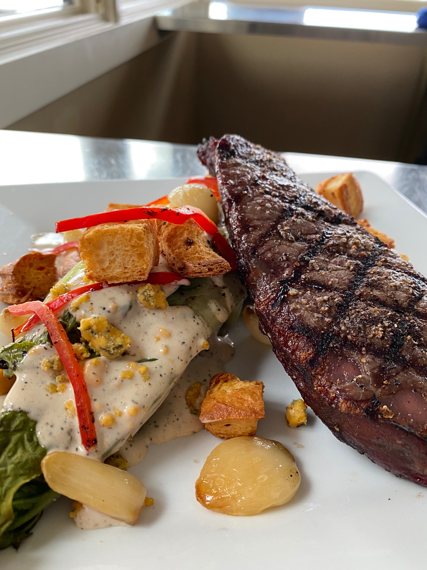 Grilled steak with a wedge salad, blue cheese, and roasted potatoes