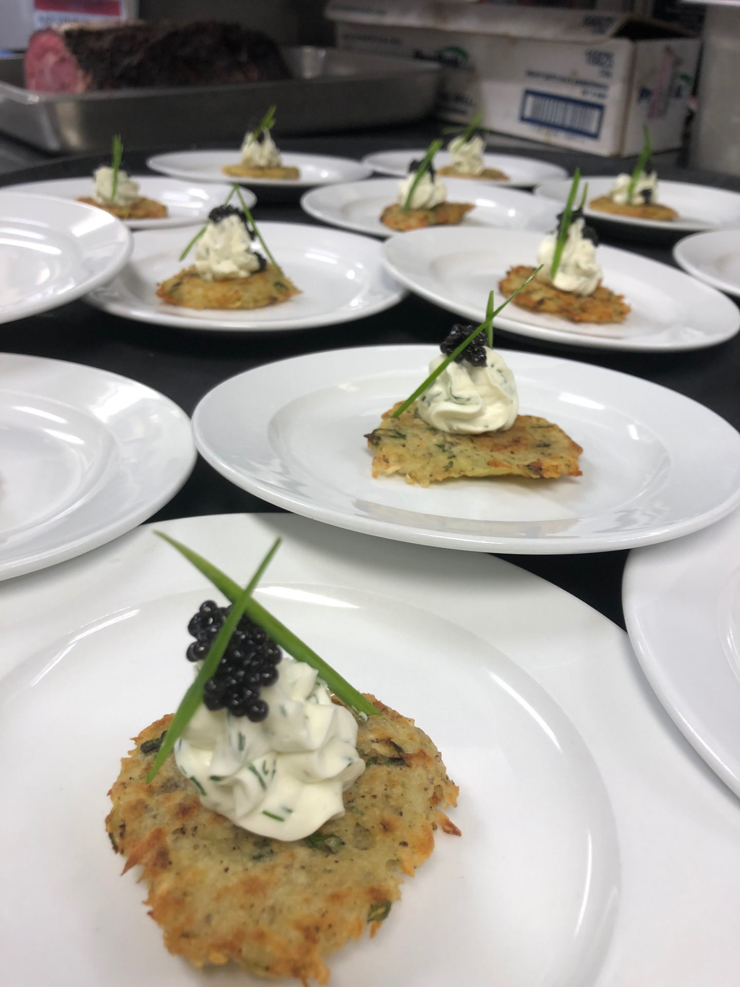 Plated potato latkes with herbed crème fraîche and caviar for a seated course