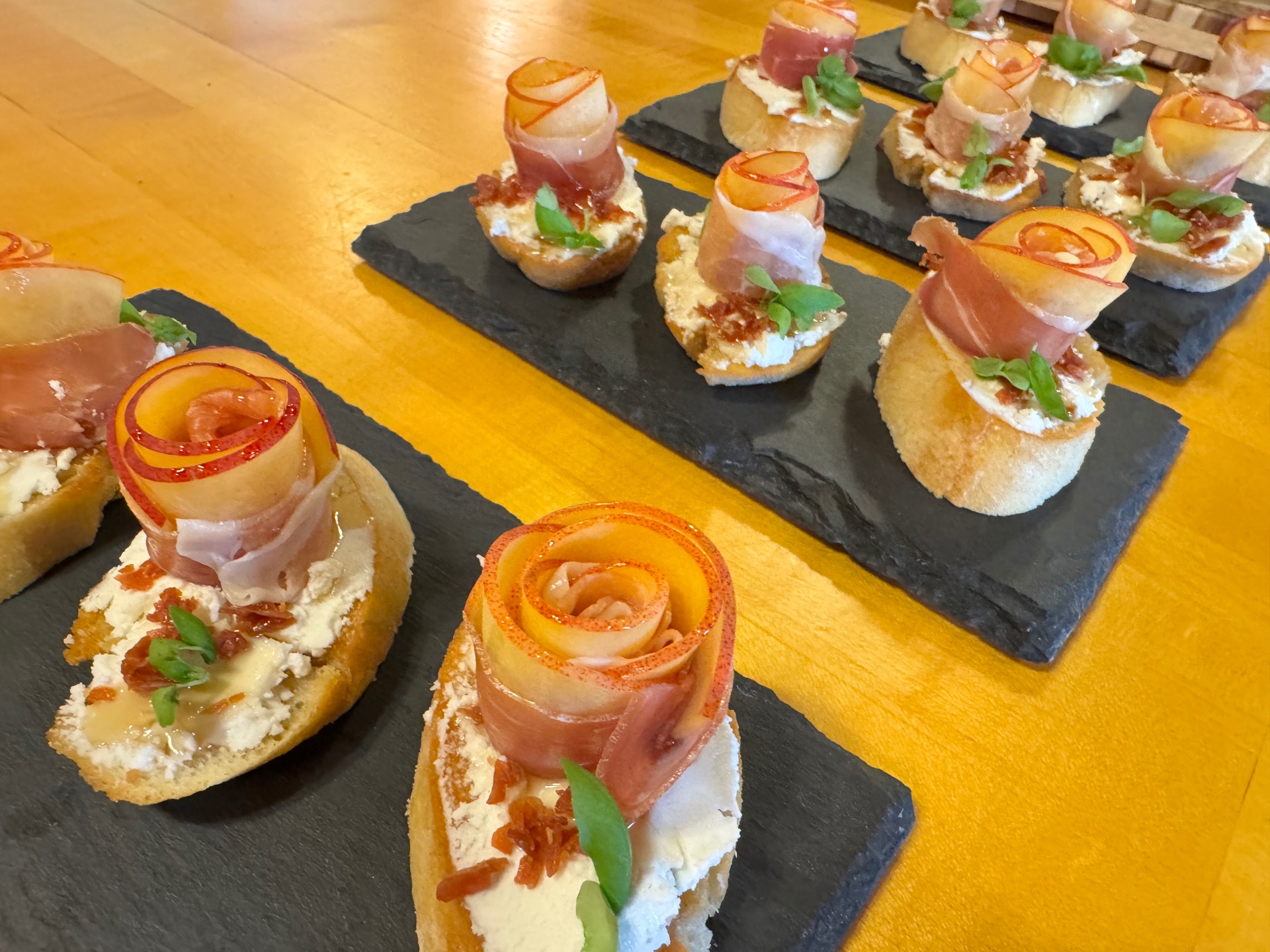 Prosciutto-wrapped melon crostini with goat cheese, basil, and honey