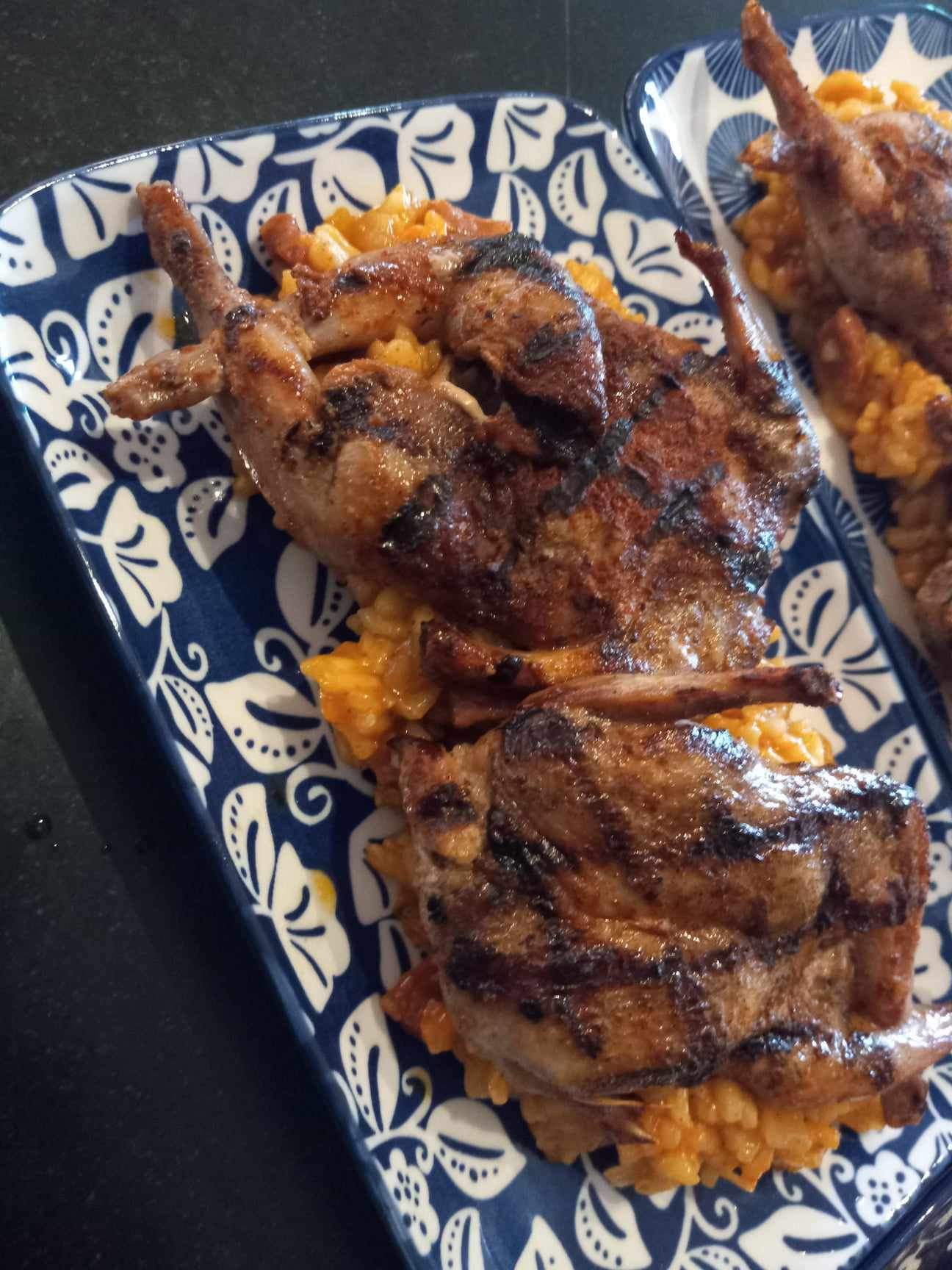 Grilled quail over saffron risotto on hand-painted platters