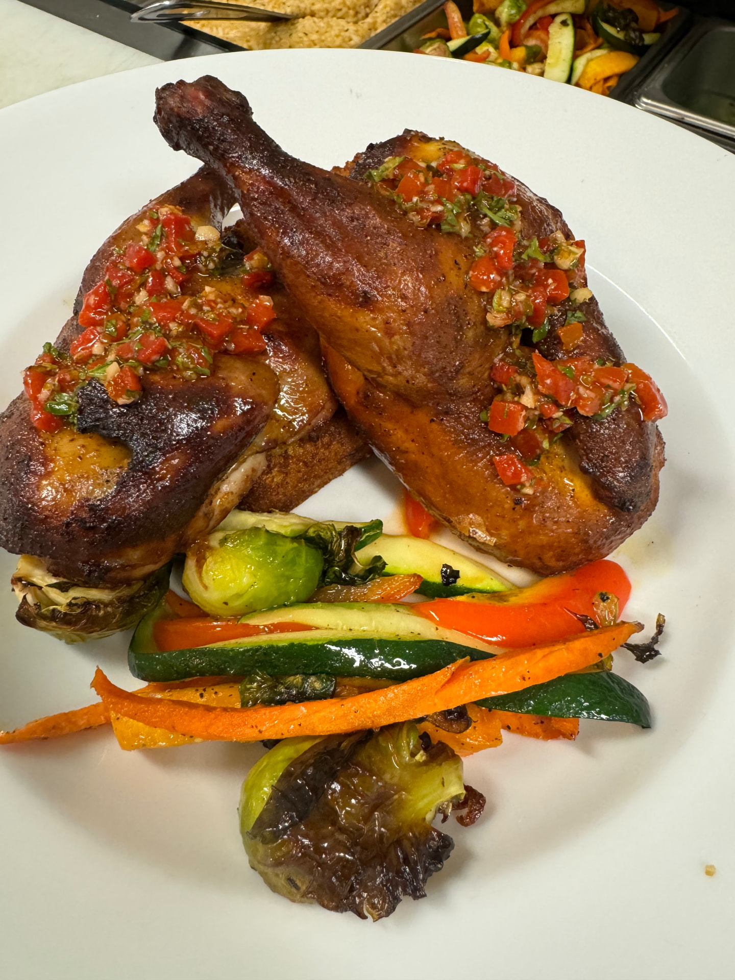 Roasted chicken quarters topped with fresh red pepper relish
