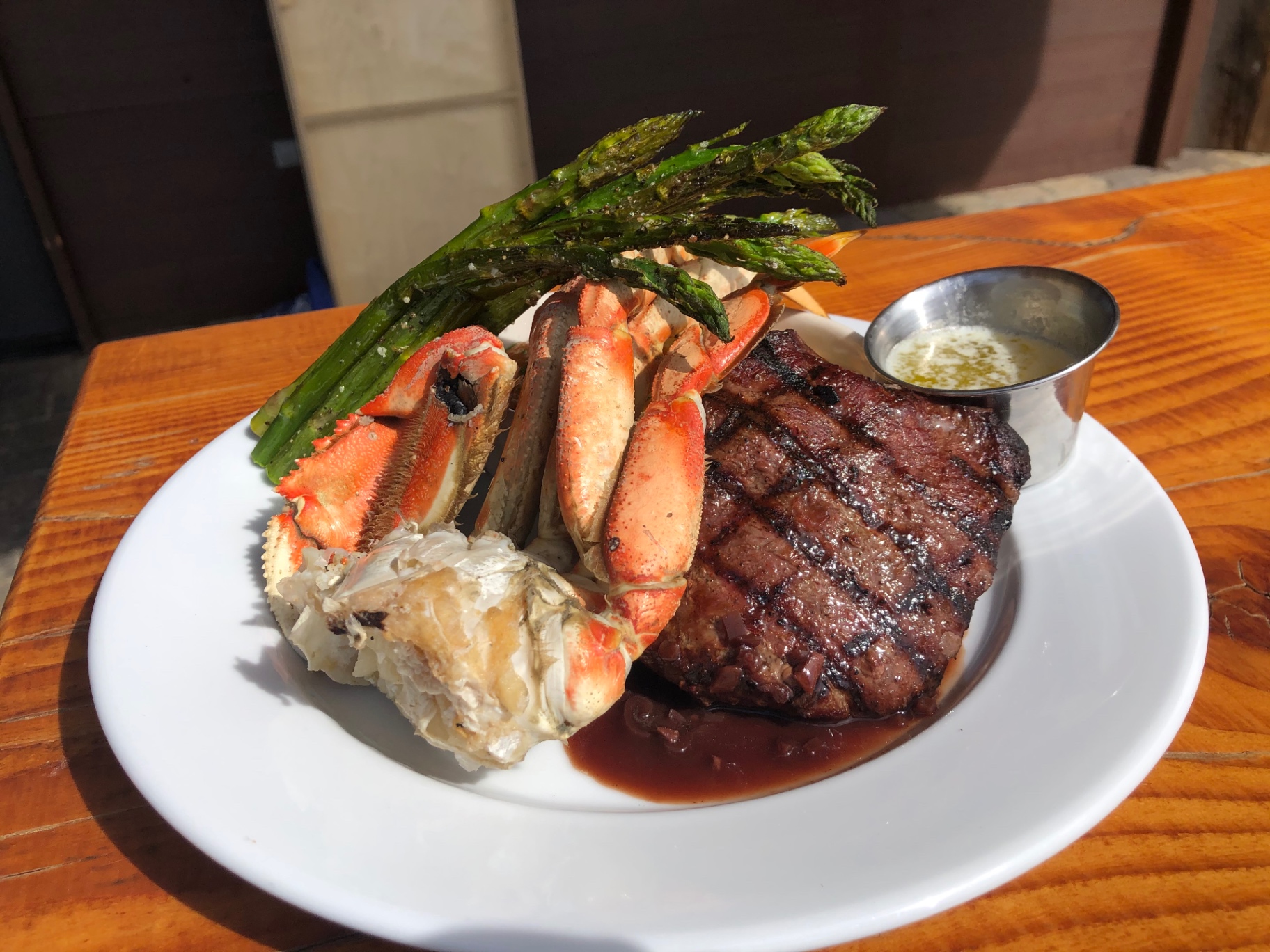 Grilled ribeye with snow crab legs, drawn butter, and charred asparagus